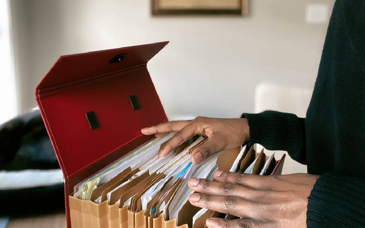 A person going through their personal documents. Next Avenue, finances, separated couples