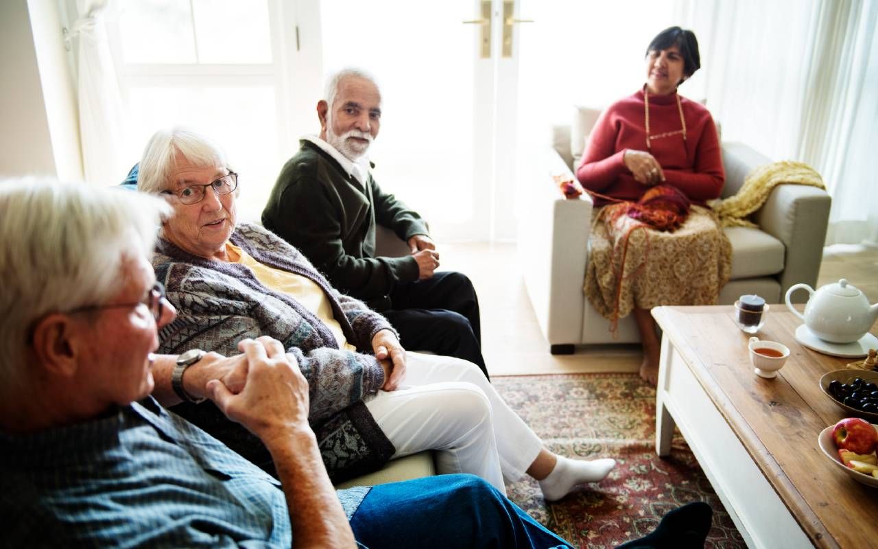 Four older adults gathering together to have a discussion. Next Avenue, cohousing