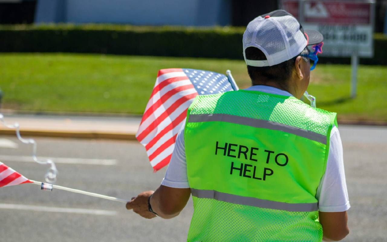 A volunteer helping at an event. Next Avenue, altruism, older adults, volunteering