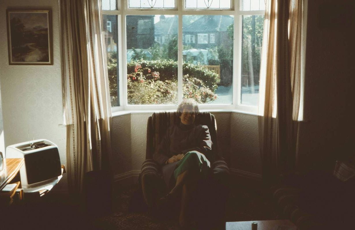 A semi transparent woman sitting in an arm chair. Next Avenue, Ambiguous loss