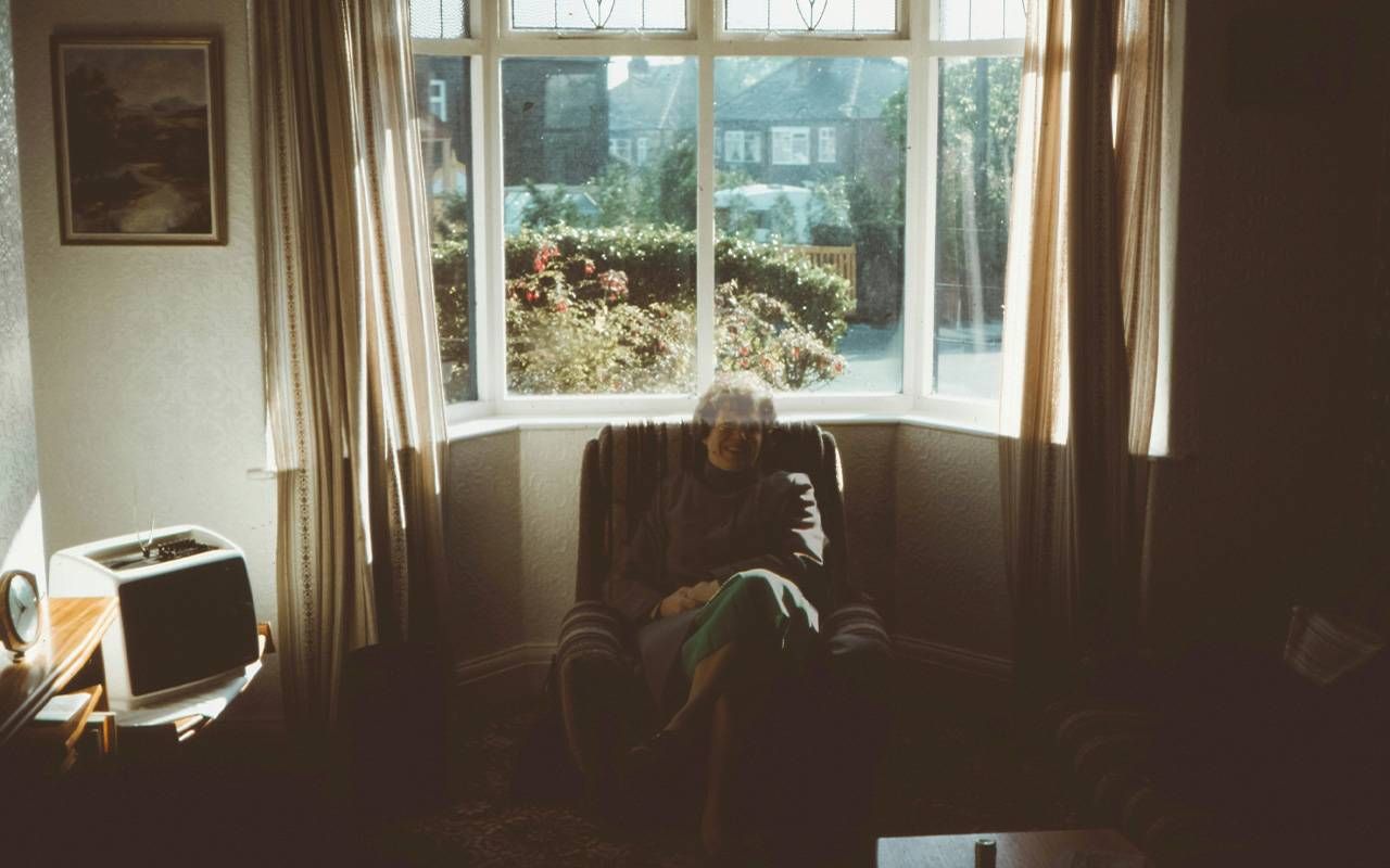 A semi transparent woman sitting in an arm chair. Next Avenue, Ambiguous loss