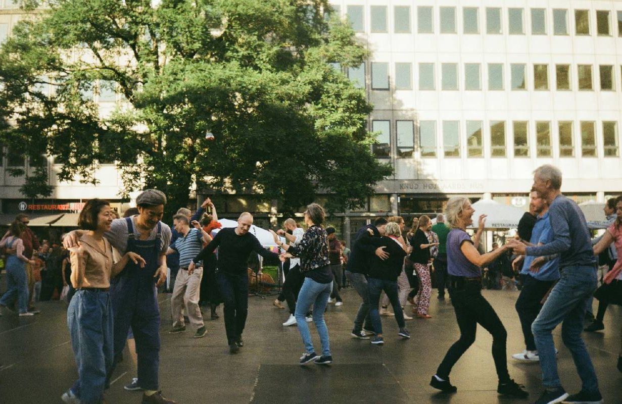 A group of people dancing outside. Next Avenue, boost brain health