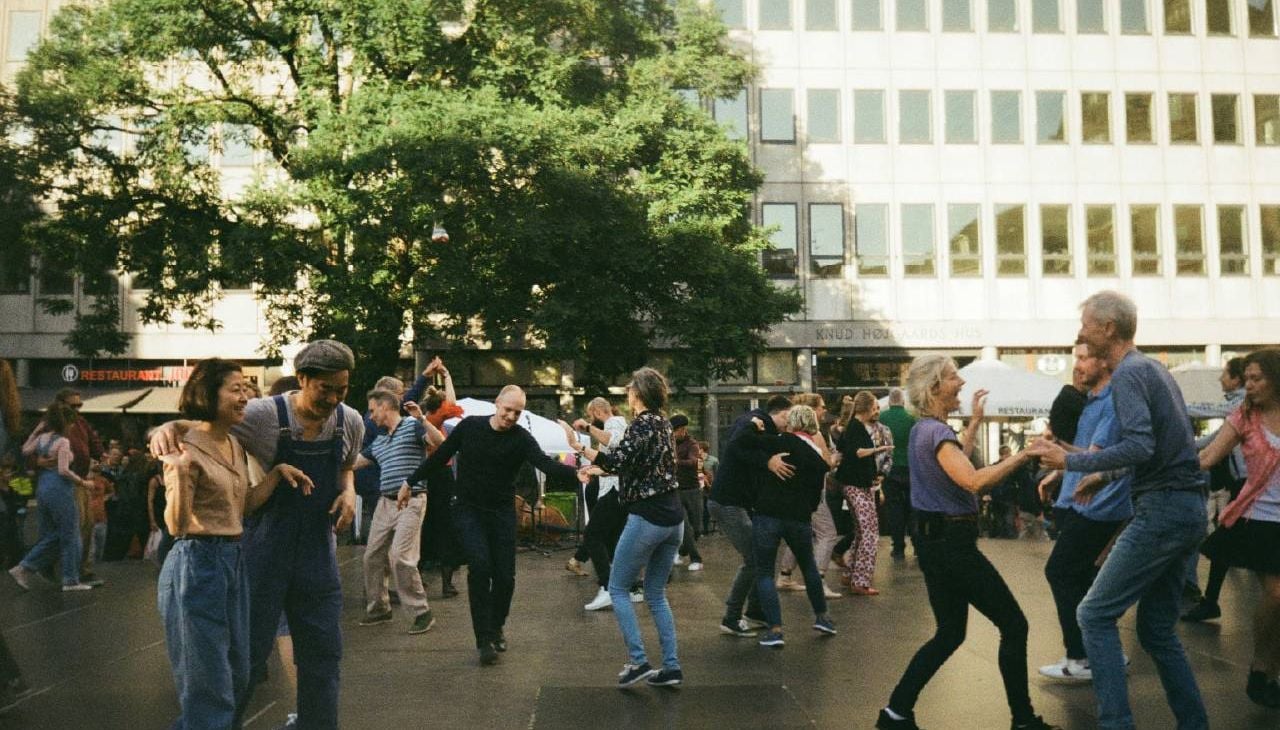 A group of people dancing outside. Next Avenue, boost brain health