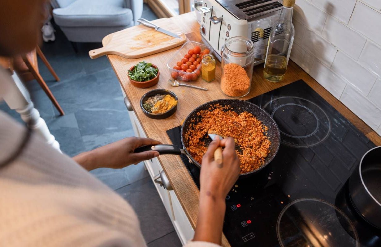 A woman cooking a meal with lentils. Next Avenue, healthy eating, what to eat