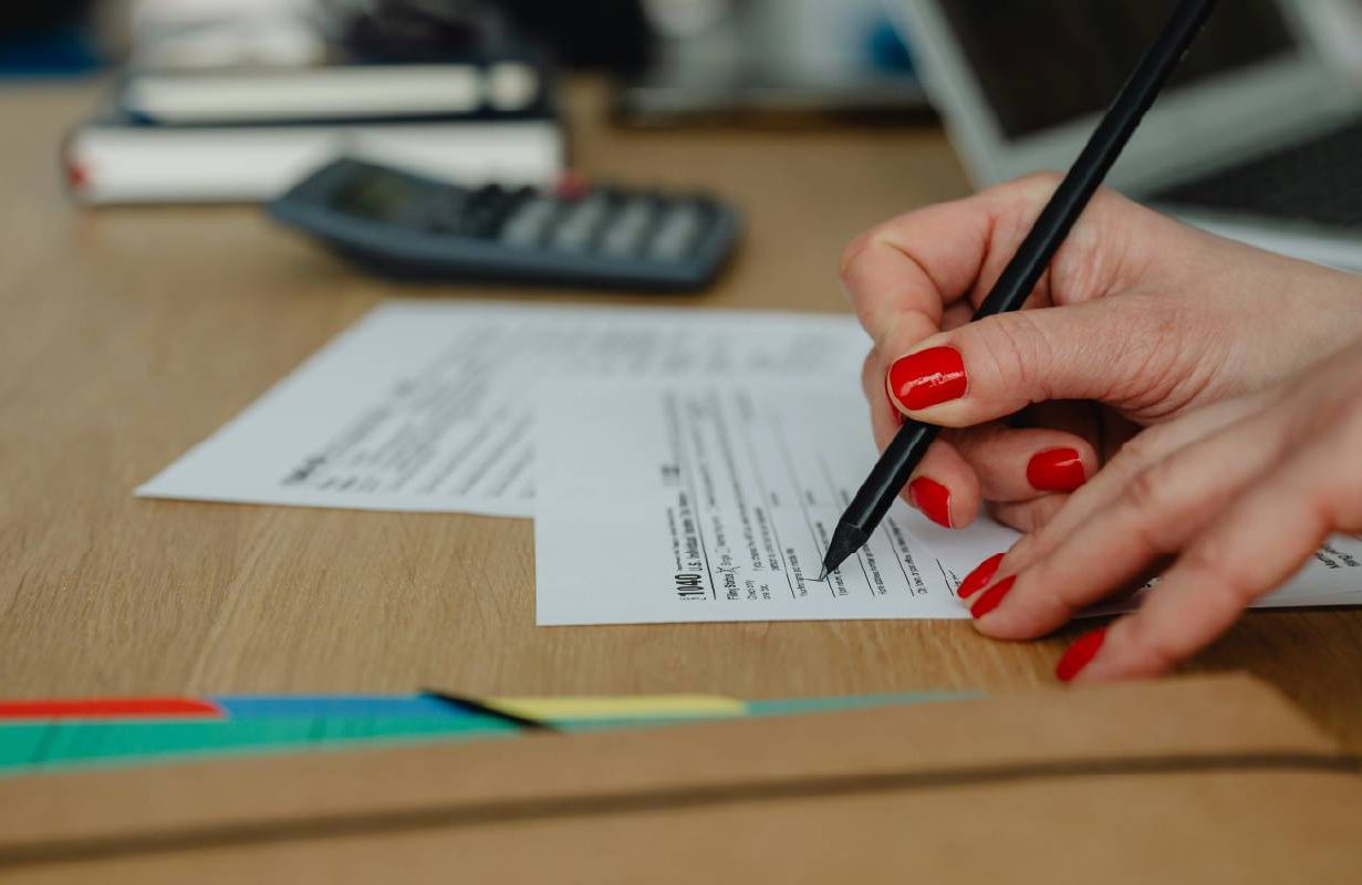 A person filling out their tax form. Next Avenue, tax extension