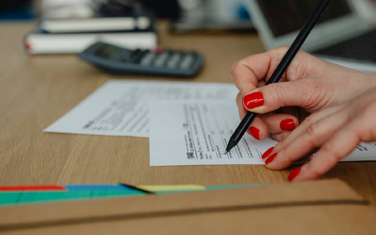 A person filling out their tax form. Next Avenue, tax extension