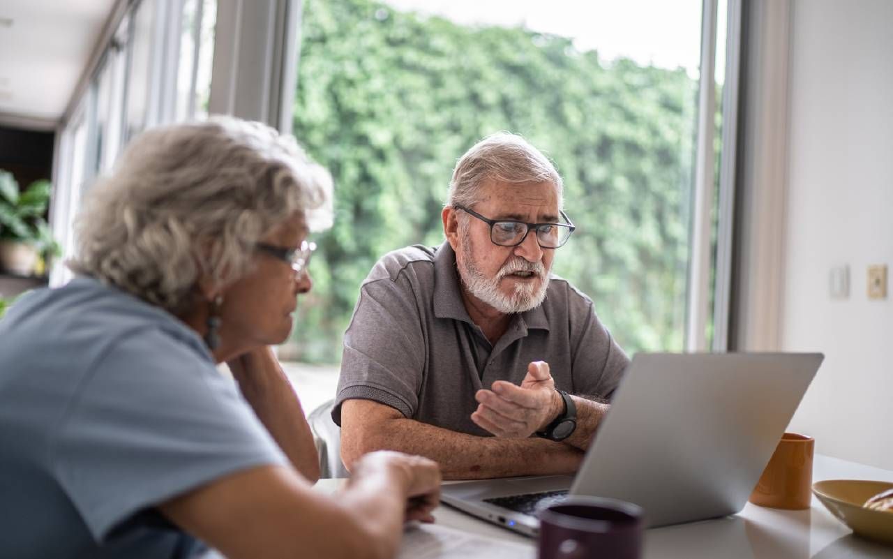 A couple looking at their online banking account. Next Avenue, financial fraud