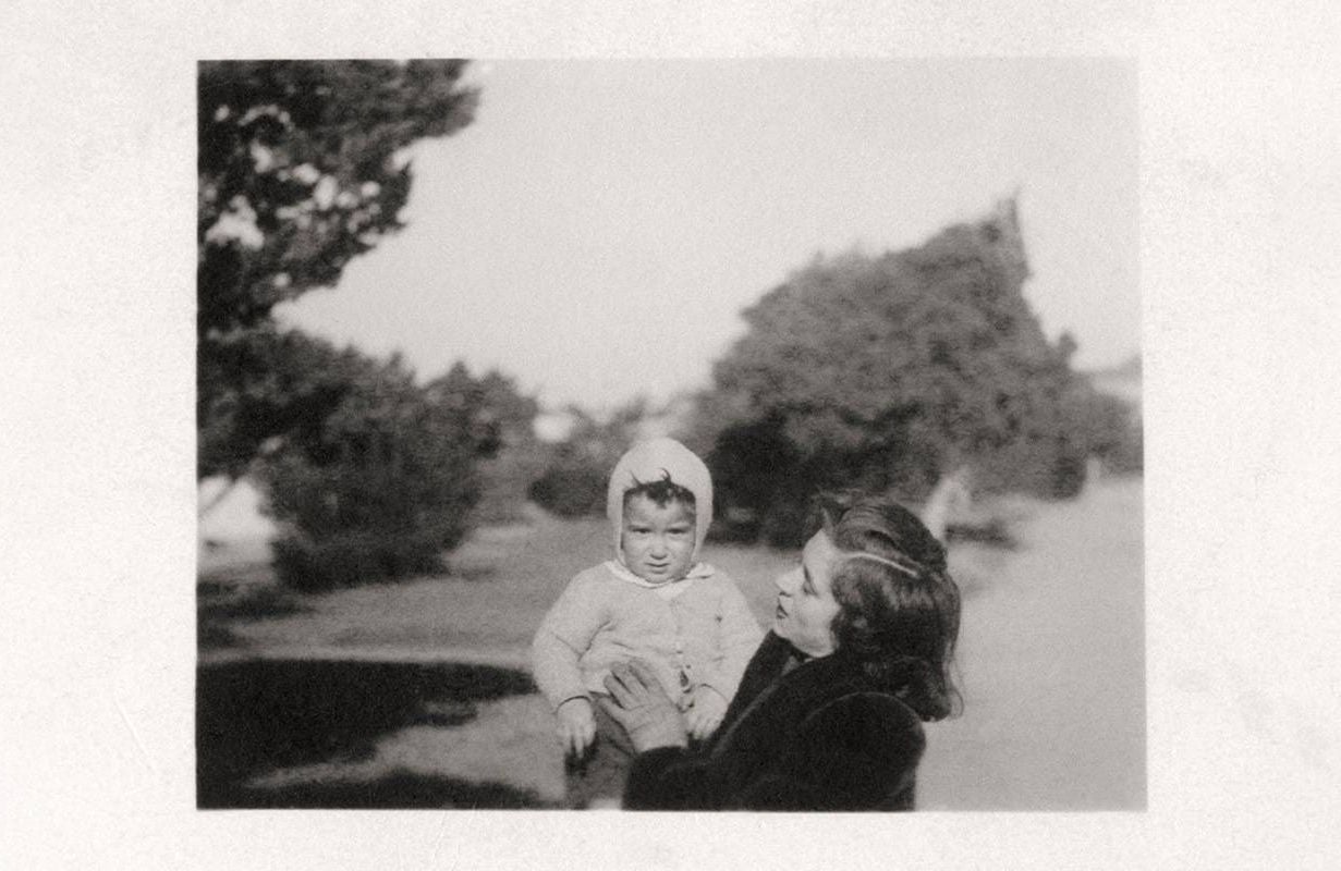 A vintage photo of a confused looking baby with her mom. Next Avenue, baby names