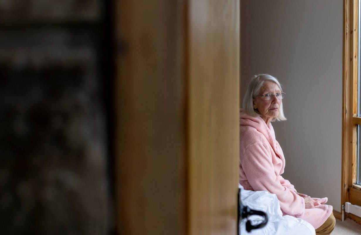 An older woman sitting on the edge of a bed. Next Avenue, longevity, health