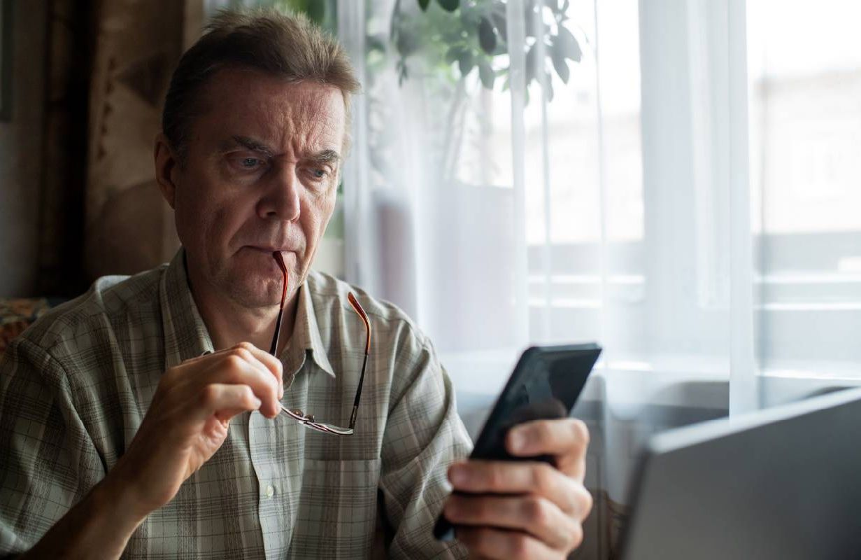 A man looking confused while reading his medical records. Next Avenue