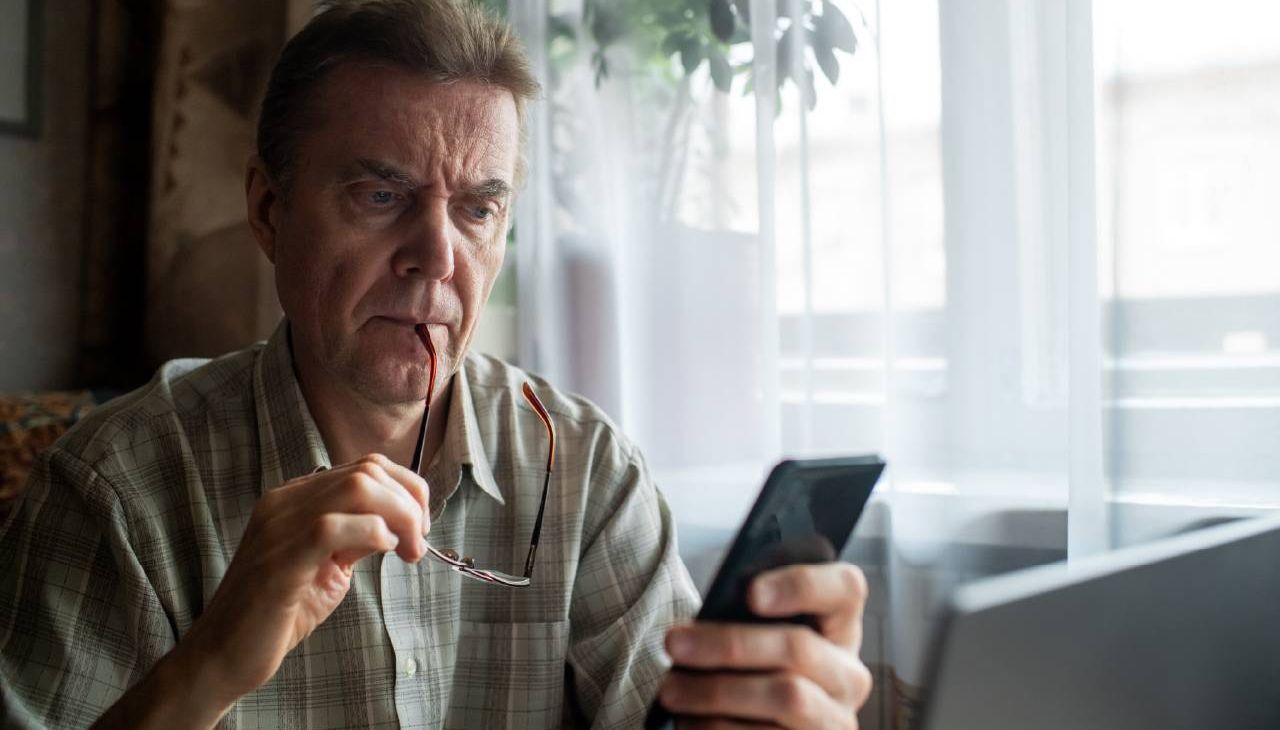 A man looking confused while reading his medical records. Next Avenue