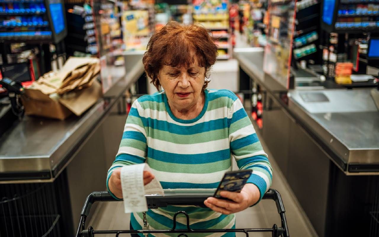 A woman reviewing her grocery bill. Next Avenue, protect against inflation