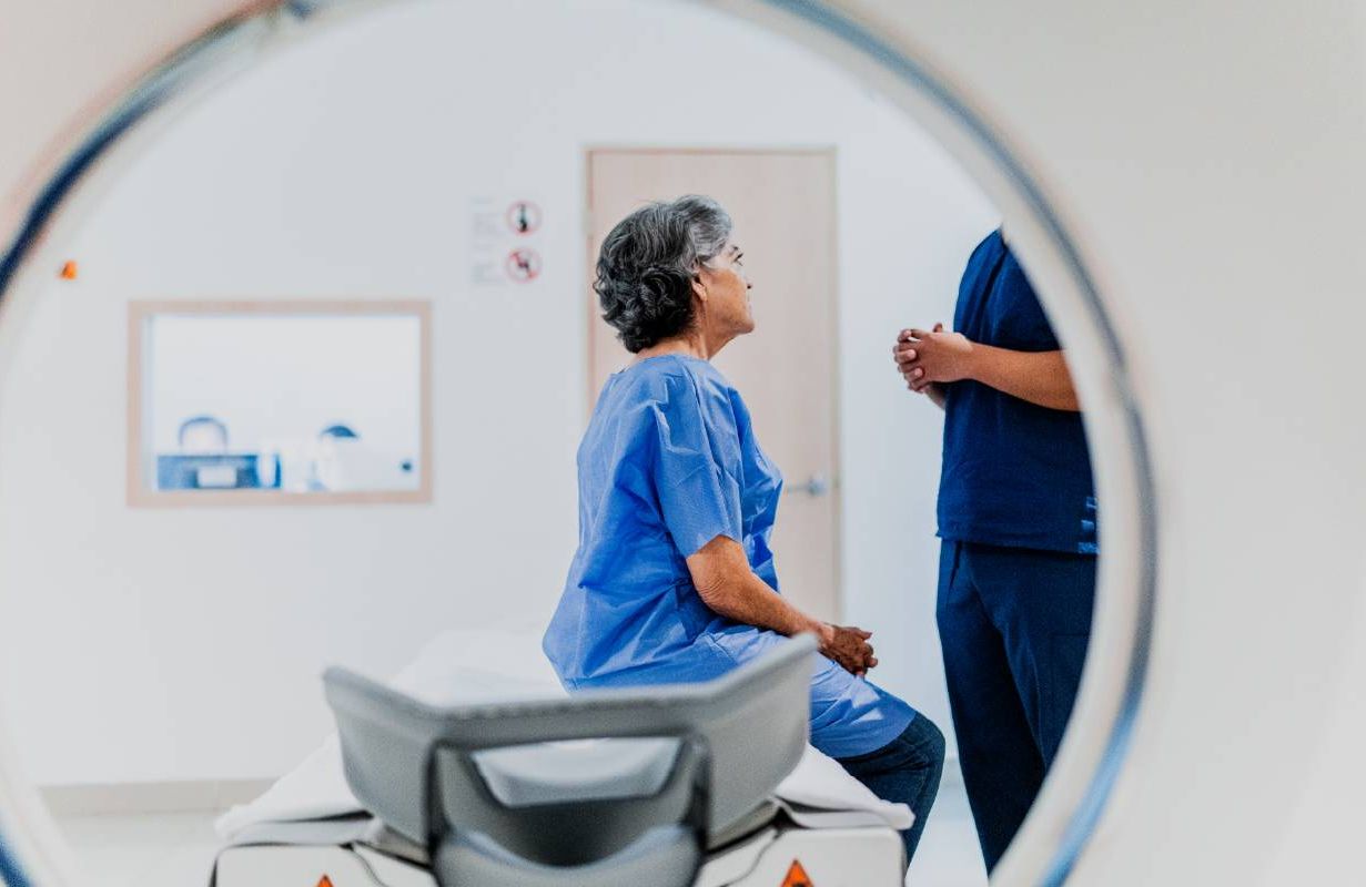 A woman talking to doctor before an MRI scan looking for symptoms of a stroke. Next Avenue