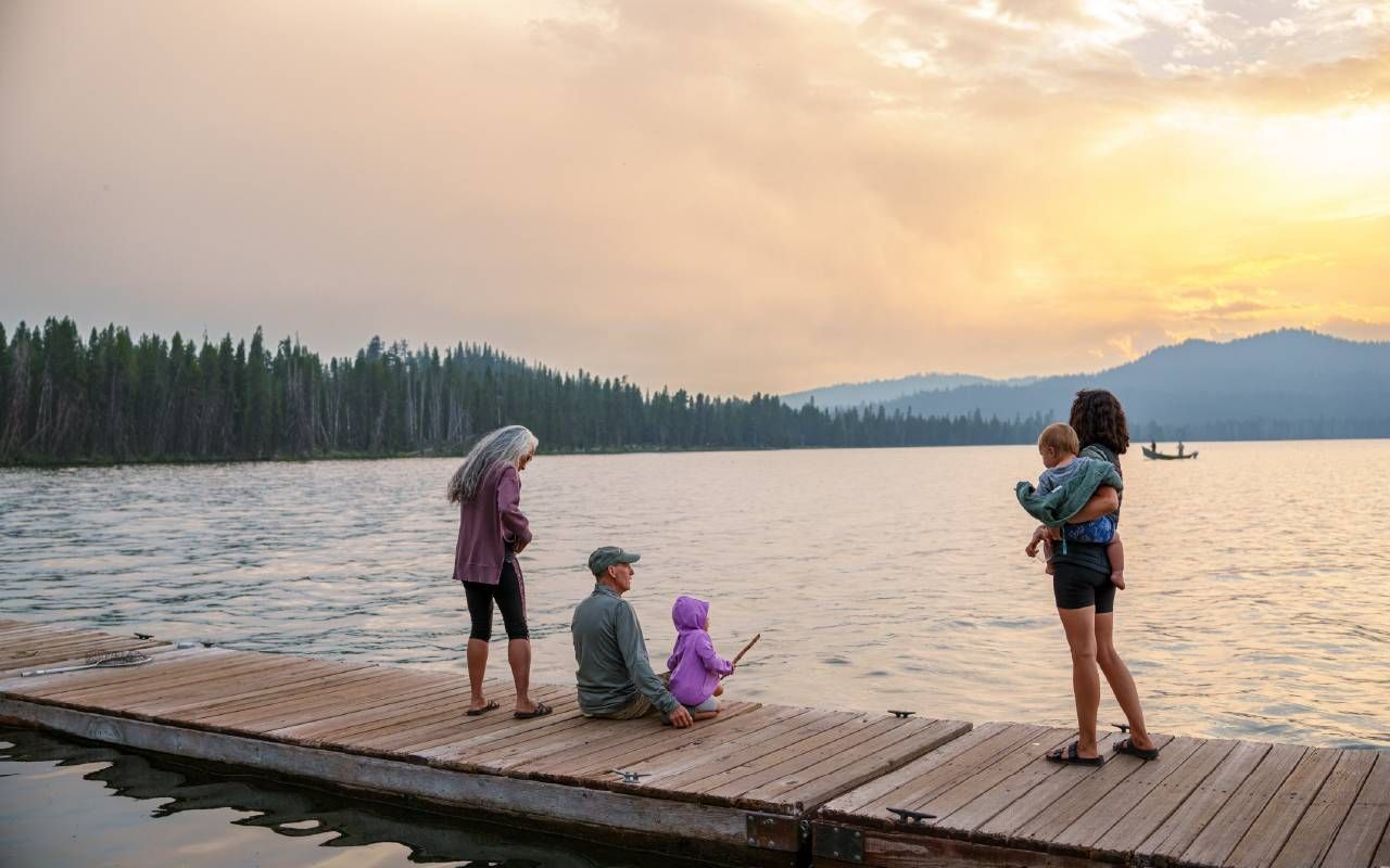 A family fishing off a dock at the lake. Next Avenue, seasonal work, retirement