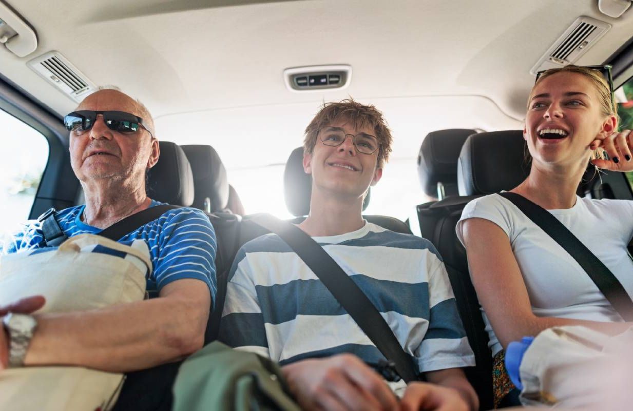 A family together inca van for a family road trip. Next Avenue, long distance, adult children