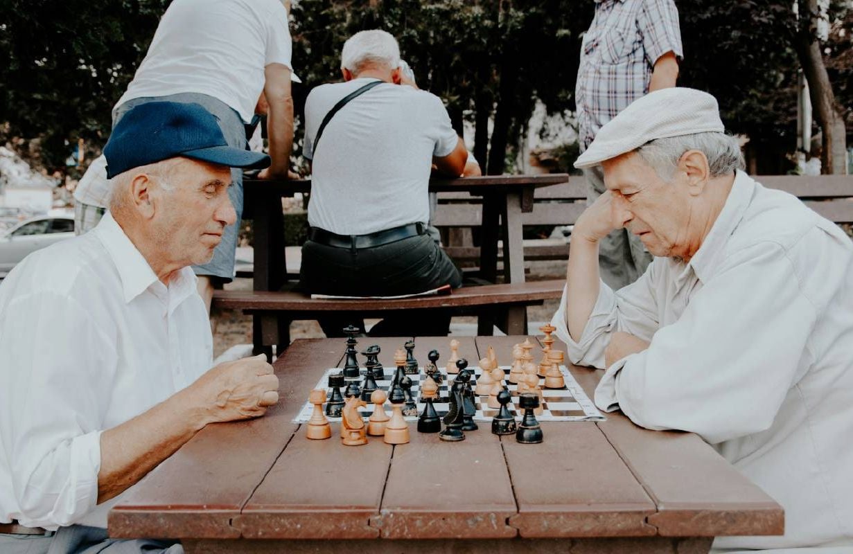People playing chess in the park. Next Avenue, brain exercises