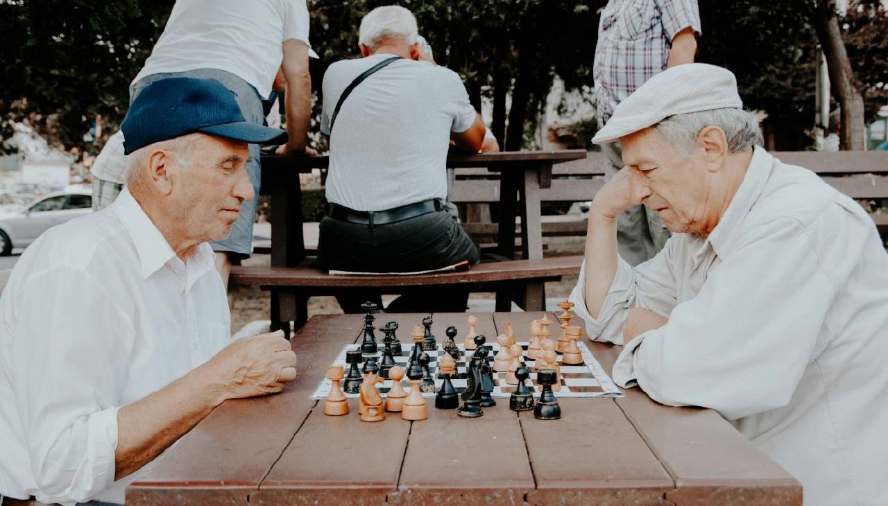 People playing chess in the park. Next Avenue, brain exercises