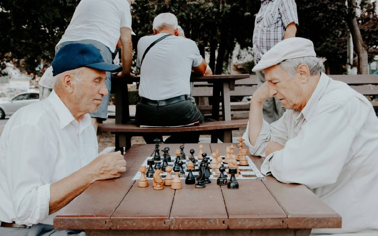 People playing chess in the park. Next Avenue, brain exercises