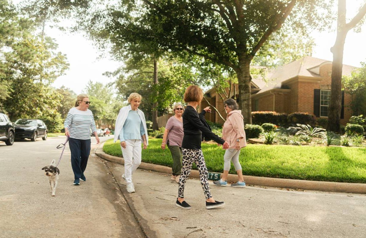 A group people walking together in their neighborhood. Next Avenue, brain health