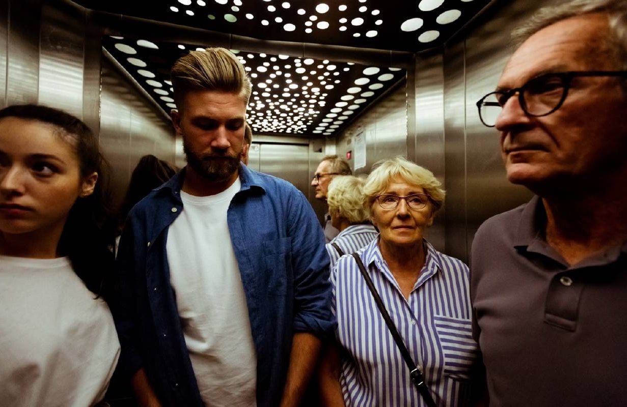 A group of people in an elevator together. Next Avenue, connecting generations