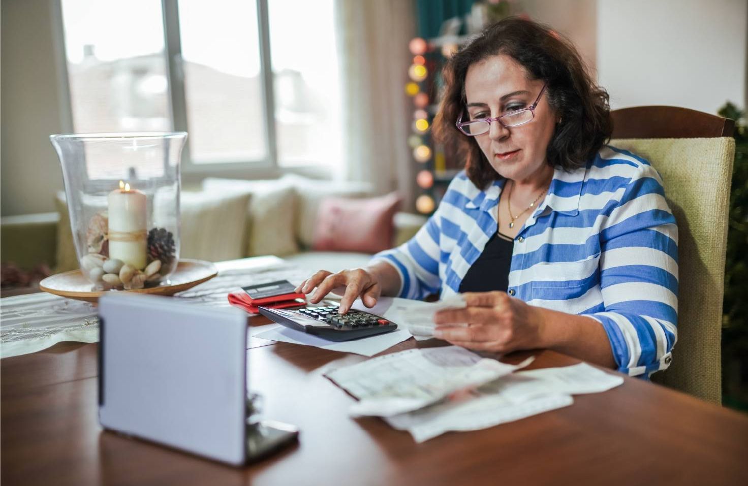 A financial mamanger paying bills. Next Avenue, debt resources
