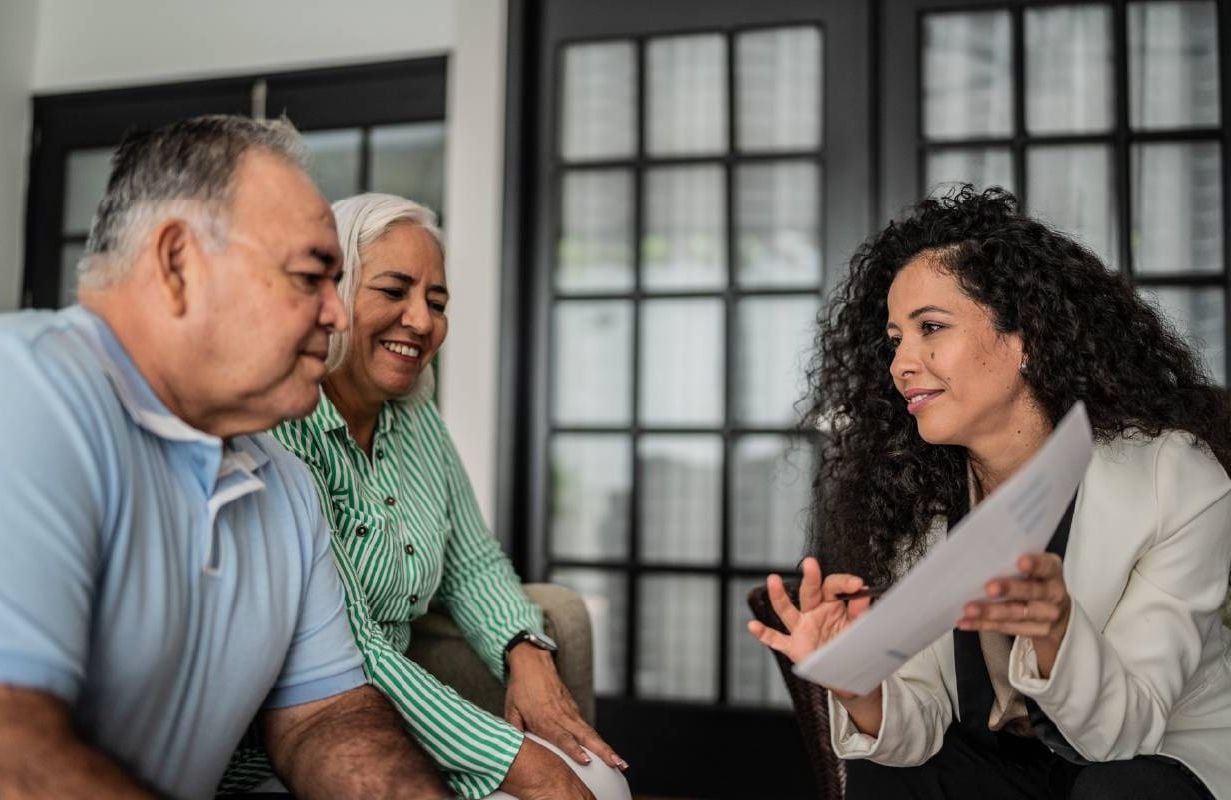 Older couple speaking with a Medicare broker. Next Avenue