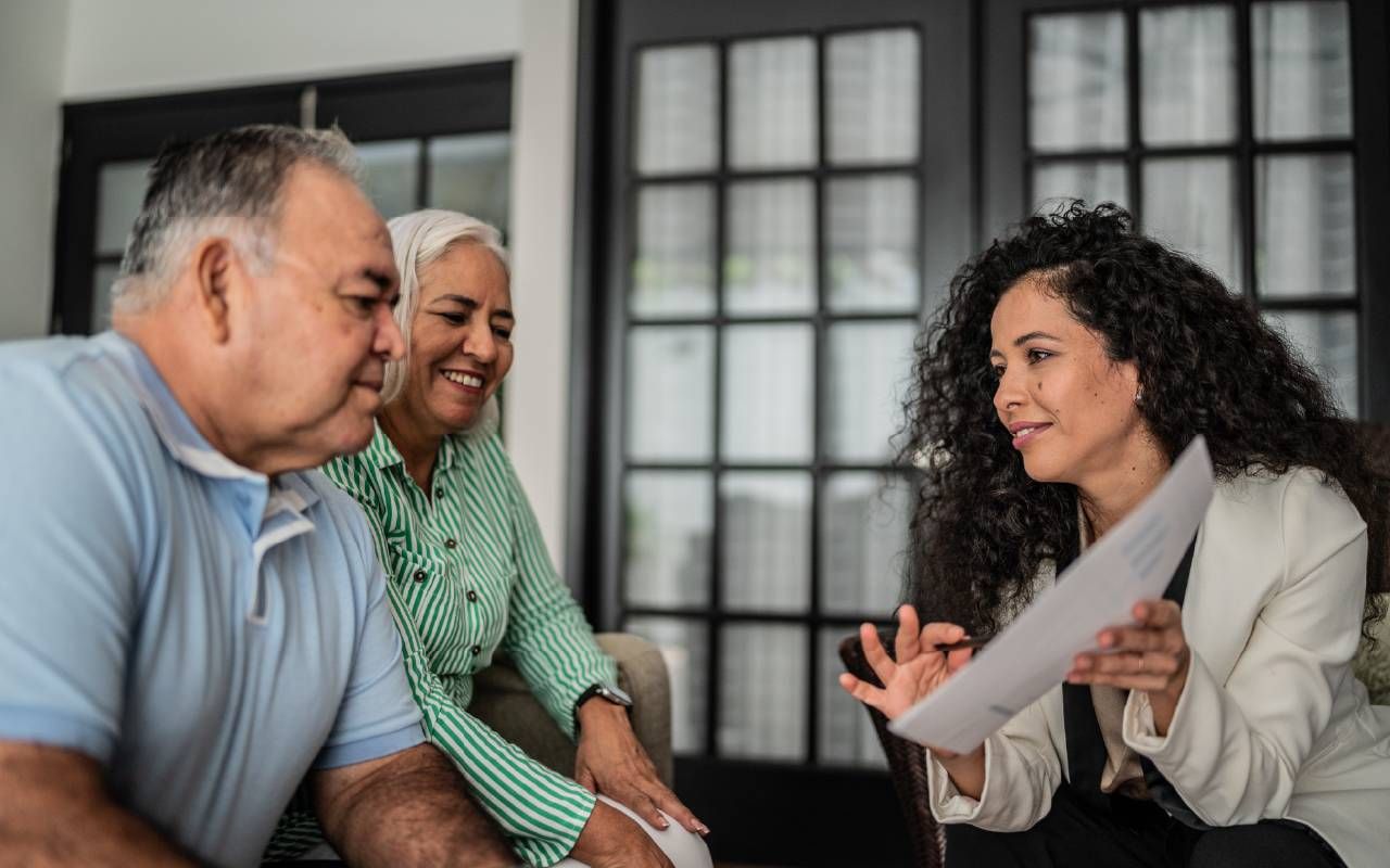 Older couple speaking with a Medicare broker. Next Avenue