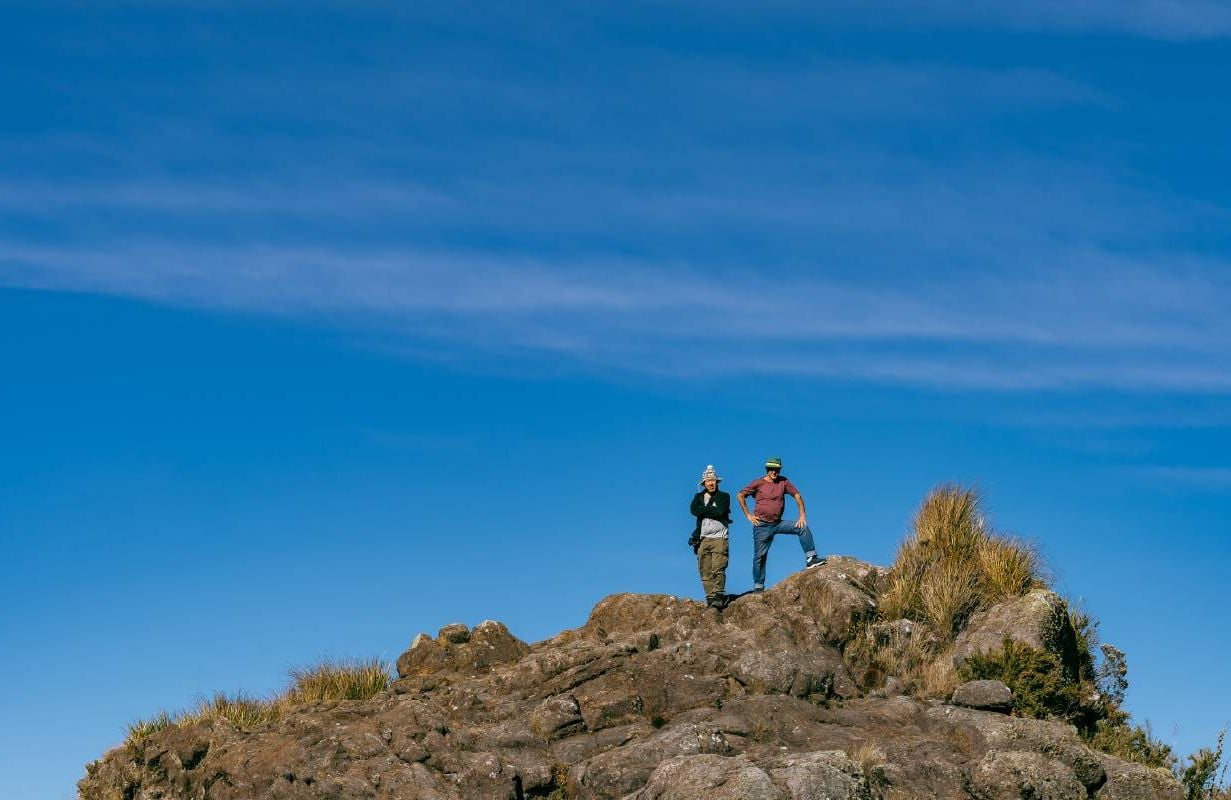 Hikers stand on top of a mountain looking at view. Next Avenue, change, aging
