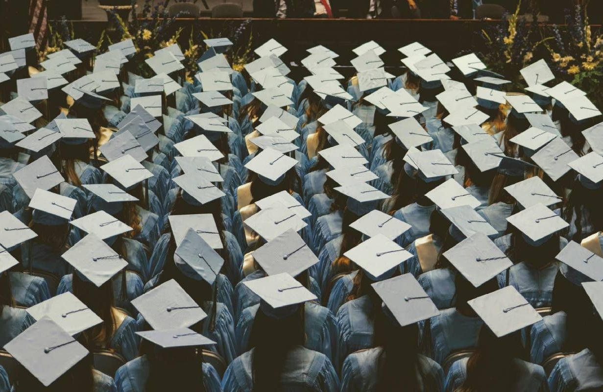College graduates sitting down. Next Avenue, student loan debt, older adults