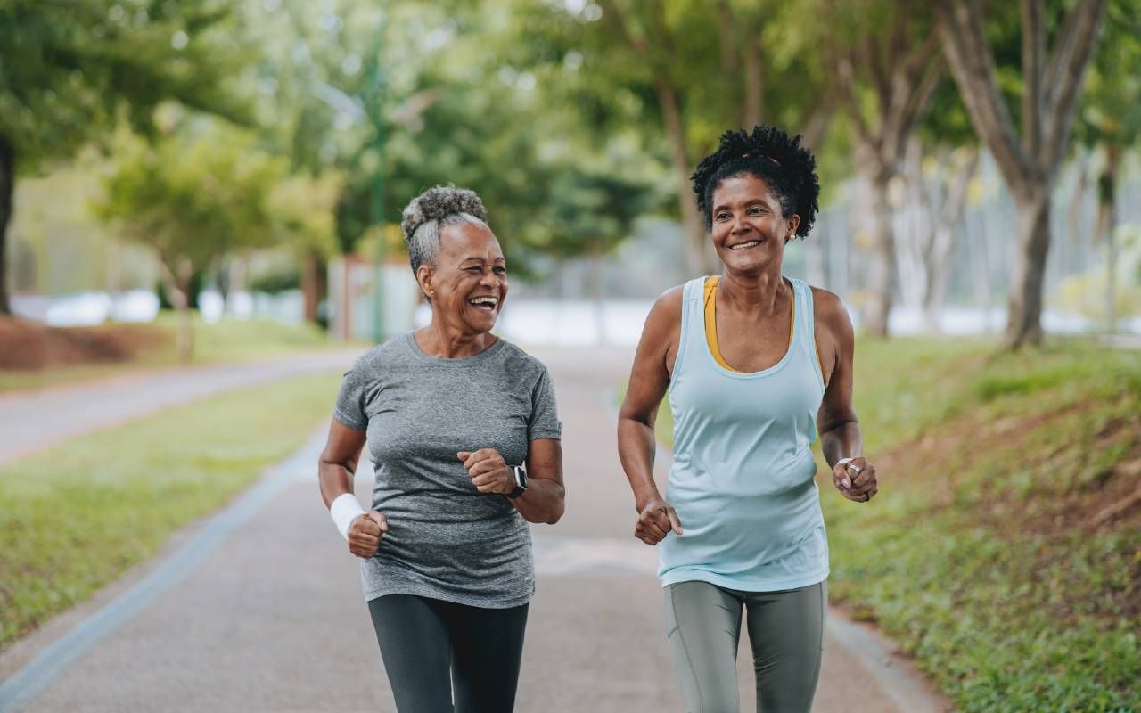 Two women exercising together. Next Avenue, breast cancer