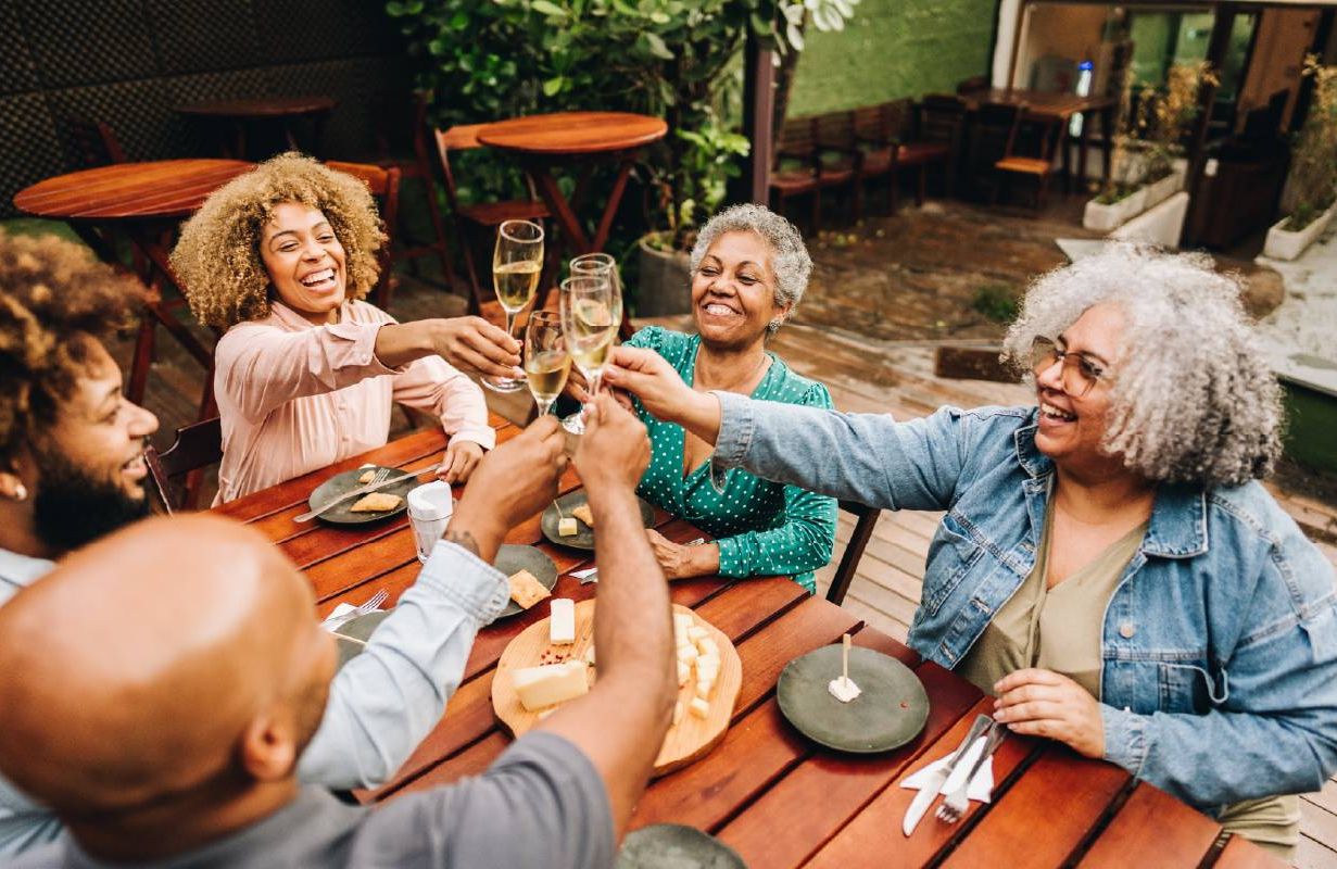 People eating together in a kitchen. Next Avenue, intuitive eating