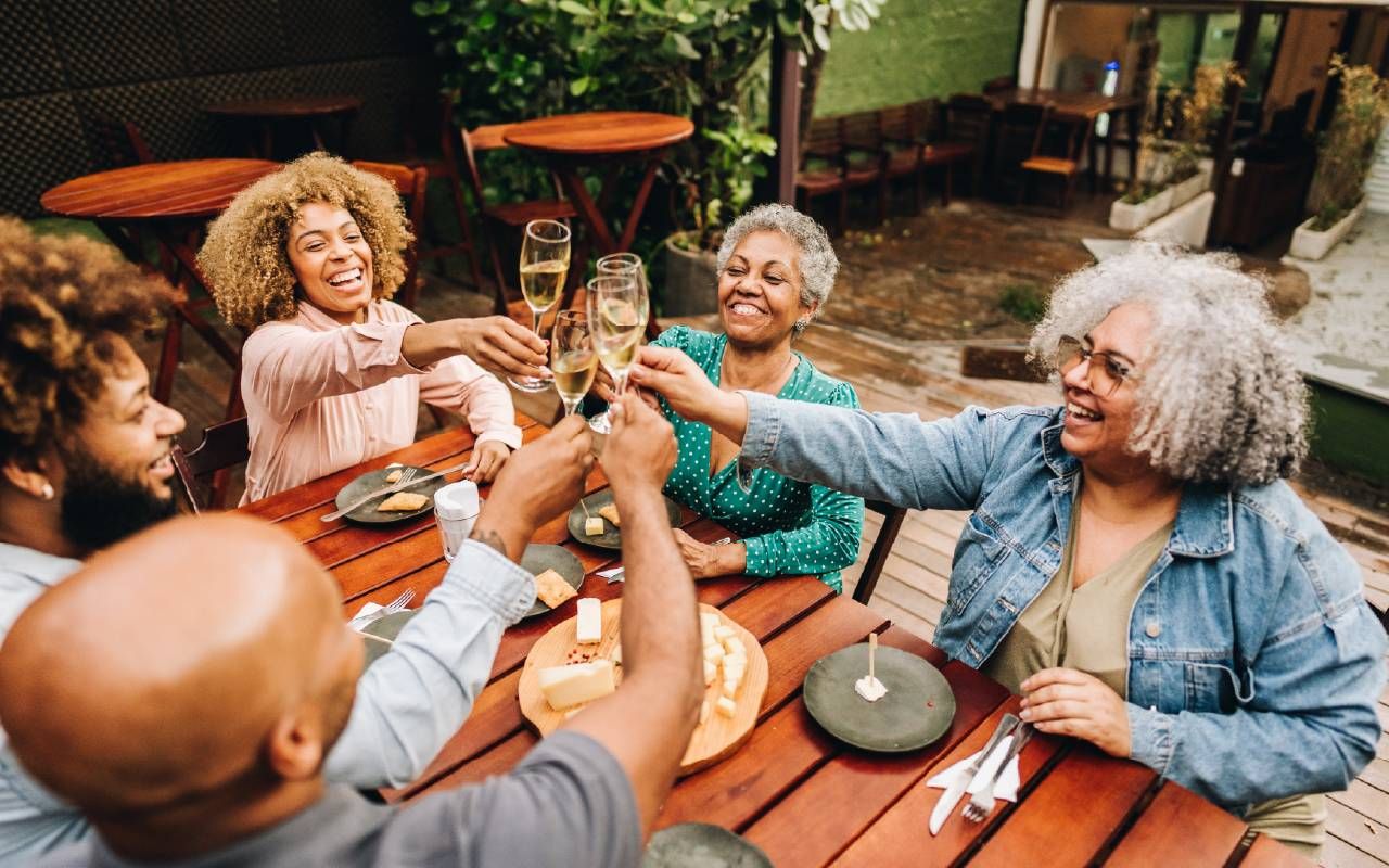 People eating together in a kitchen. Next Avenue, intuitive eating