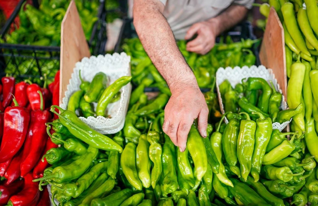A person shopping at a farmer's market. Next Avenue, whole food plant-based diet