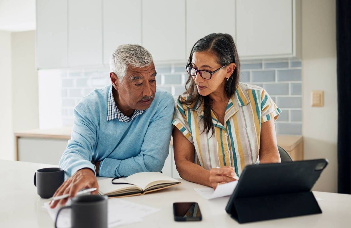 A couple looking at creating a savings account in retirement. Next Avenue