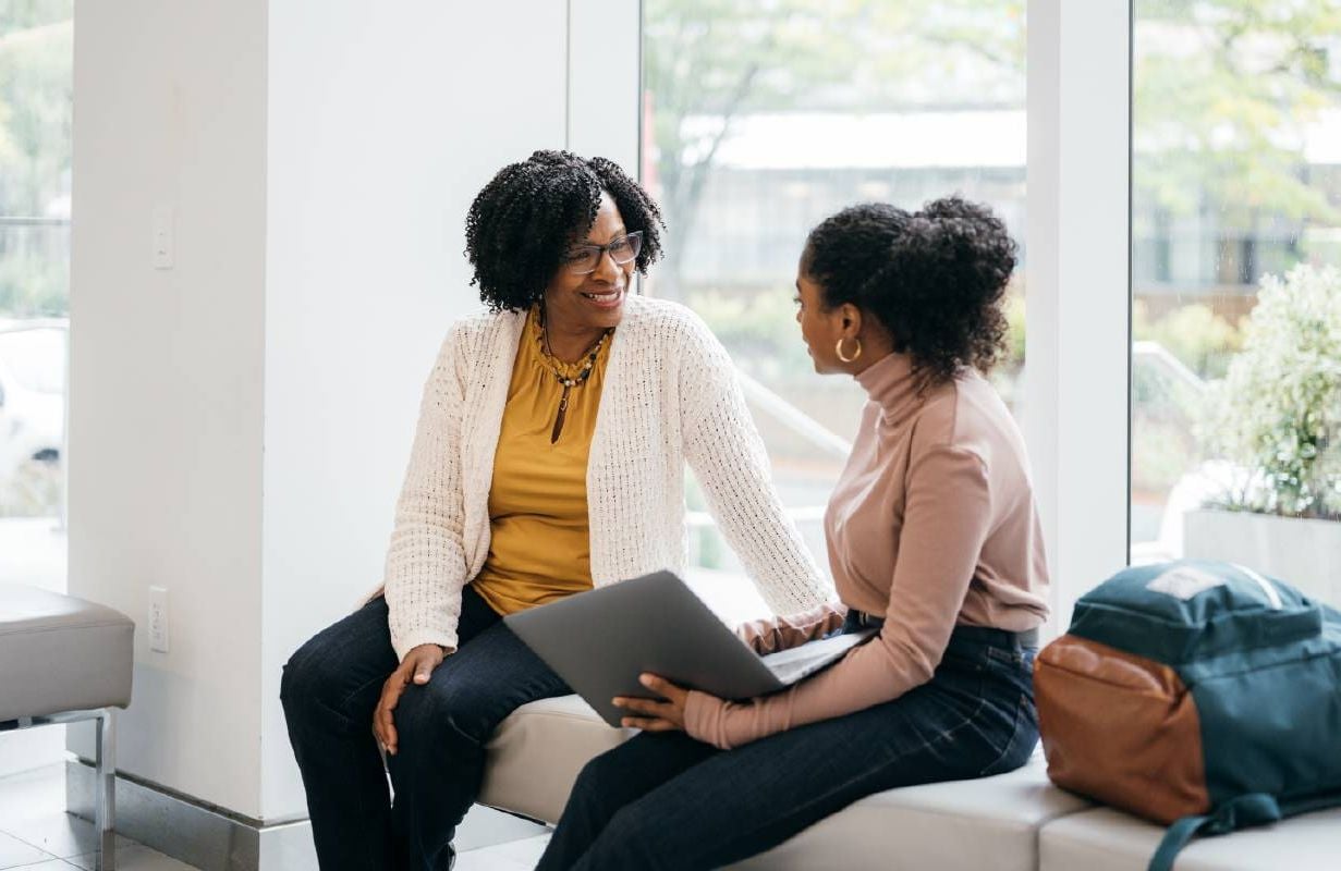 An older person mentoring another person at a nonprofit. Next Avenue