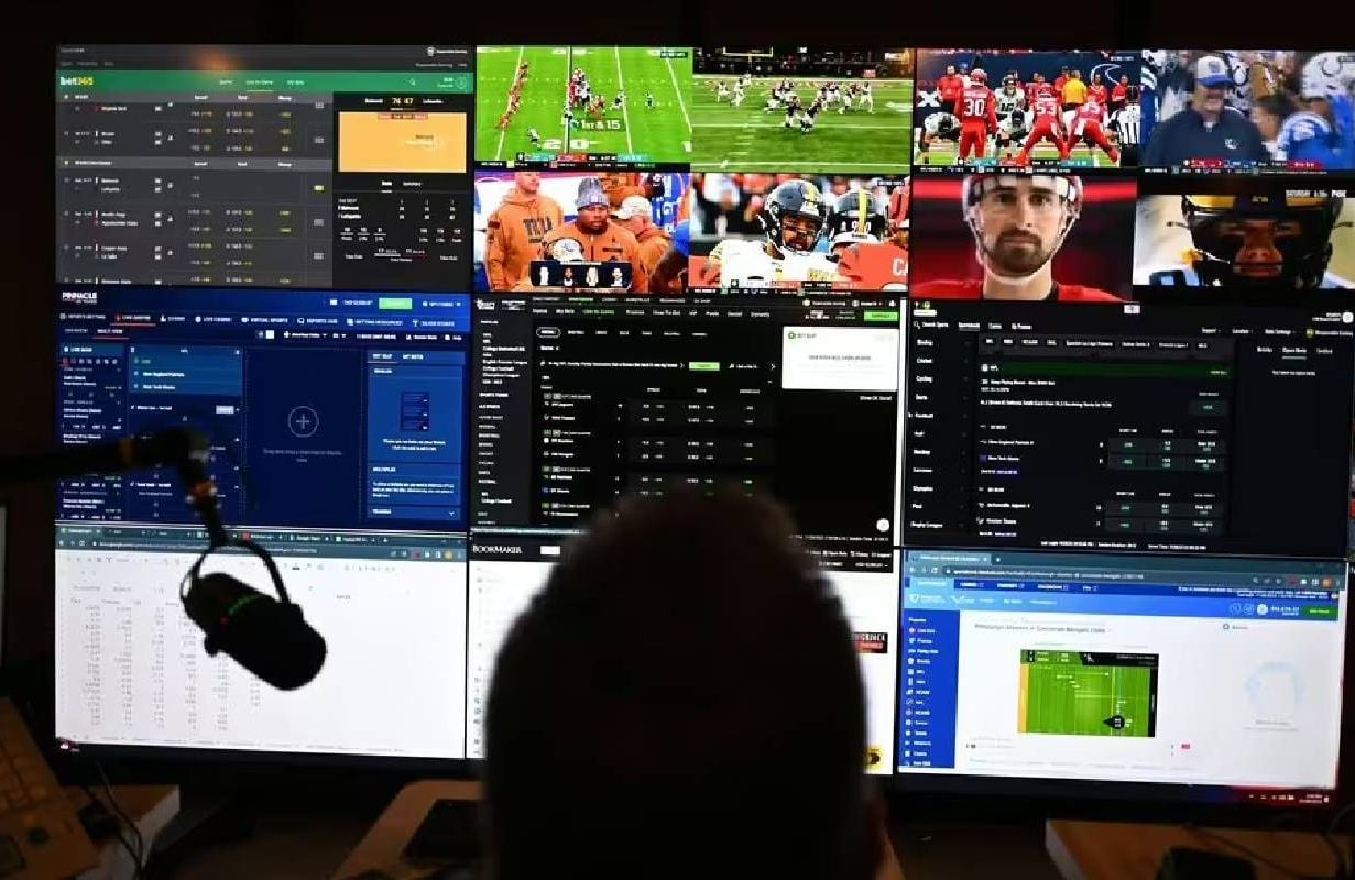 A person with multiple screens looking at sports betting odds. Next Avenue, gambling