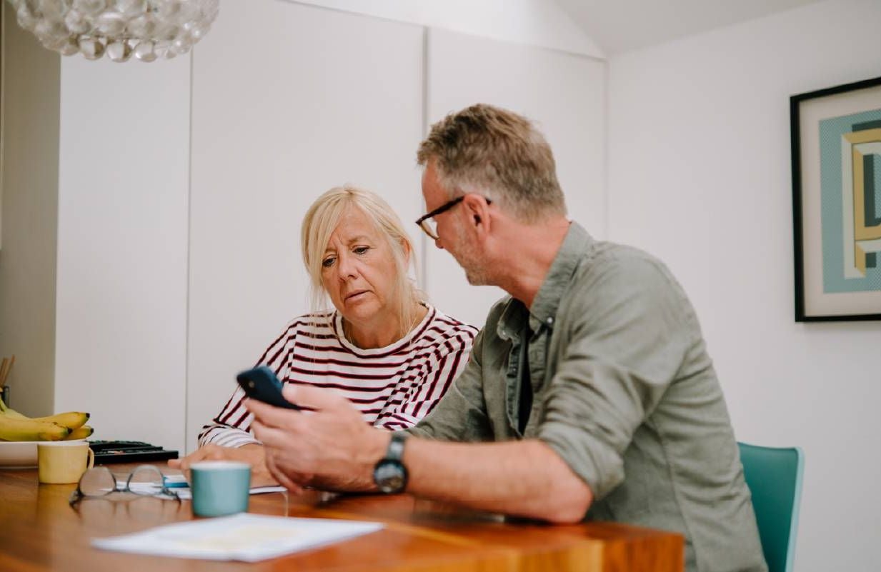 A couple going over documents together. Next Avenue, survivor benefits