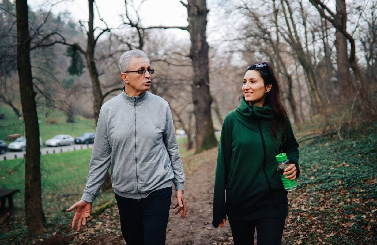 Father and daughter walking on a trail together. Next Avenue, birthrate, childless, child free