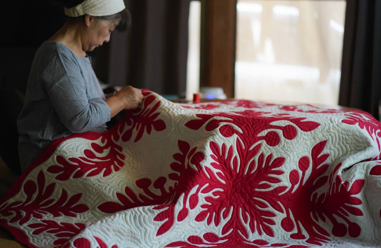 A woman quilting. Next Avenue, art vacations