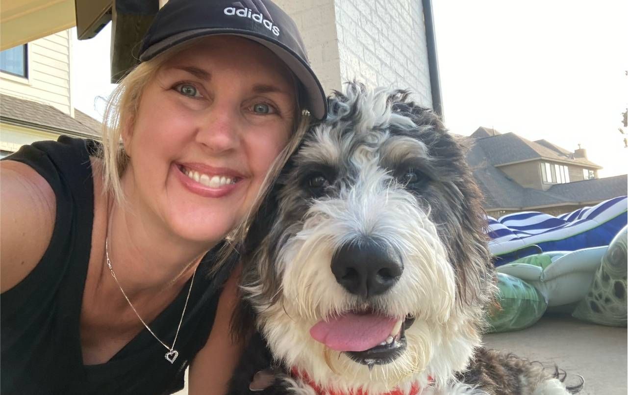 W oman smiling with a dog. Next Avenue, pet sitting