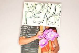 People hold world peace sign