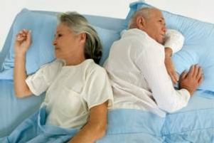Older couple asleep in bed