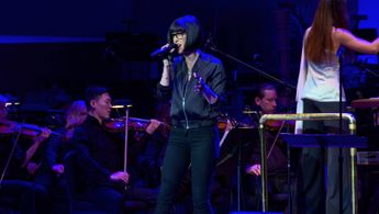 Dessa performing on stage at Orchestra Hall