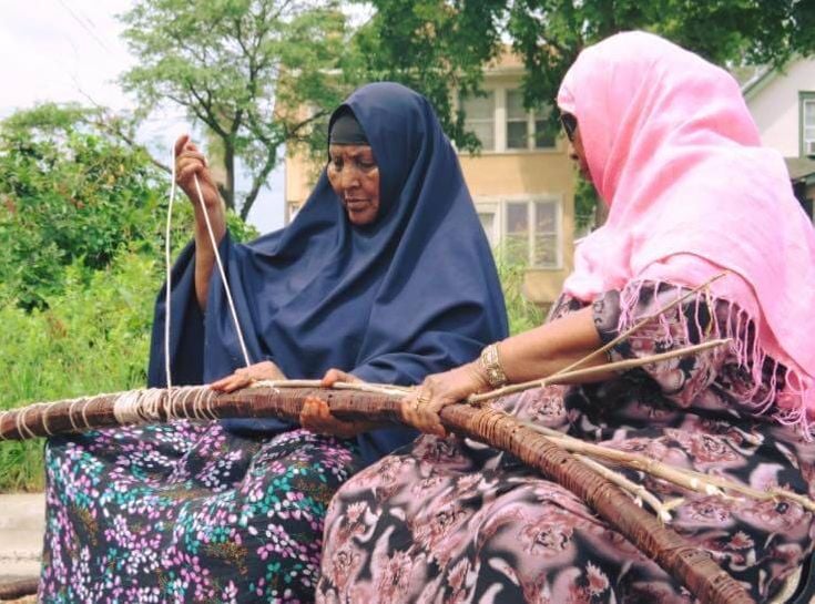 Resident weaving artists at the Somali Museum of Minnesota build a traditional hut. Photo courtesy of Somali Museum