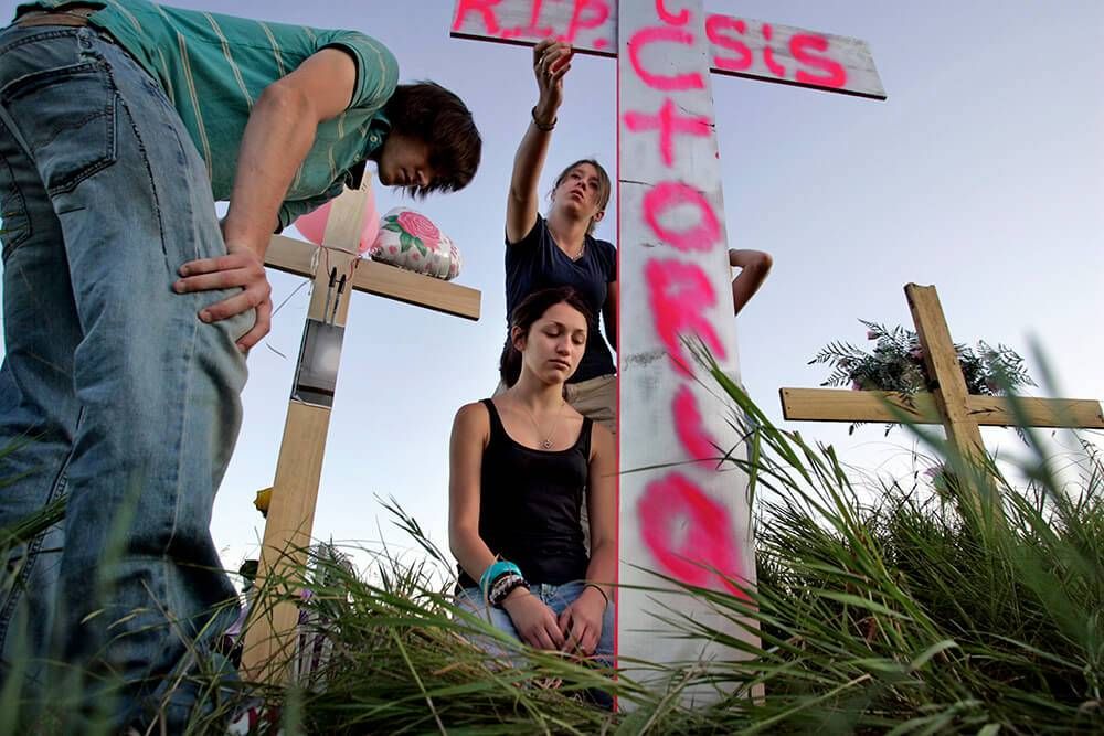 July 6, 2007, Princeton, MN – Sammie Habeck, 16, (kneeling – middle) visited the crash site where her sister Victoria Schumann Swanson, 17, and 3 others lost their lives.