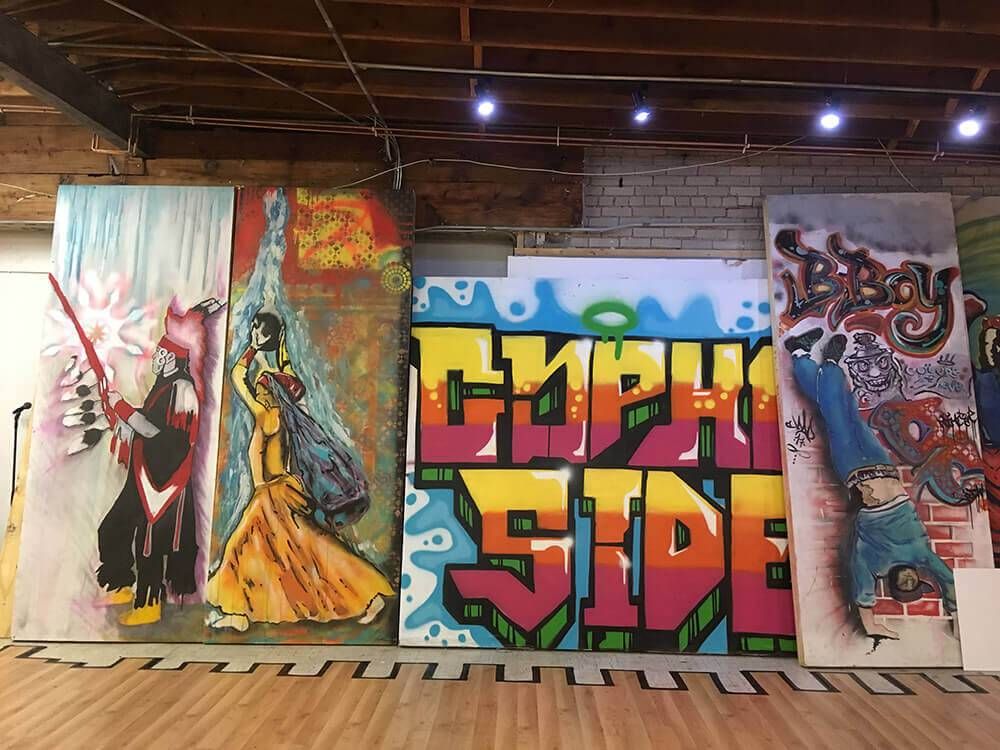 a group of paintings on a wall