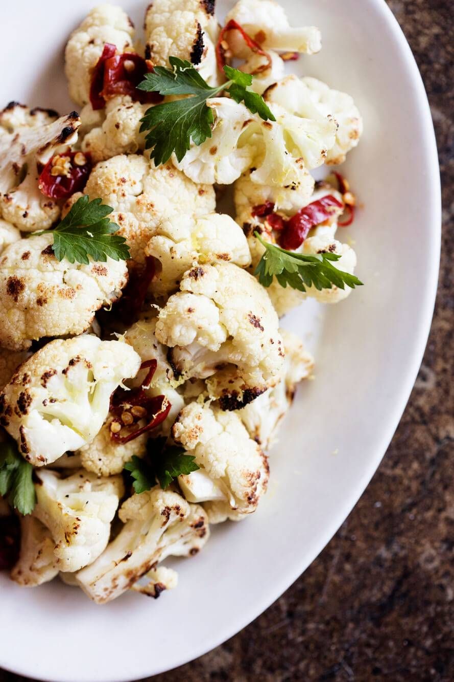 Roasted cauliflower with parsley on a white plate