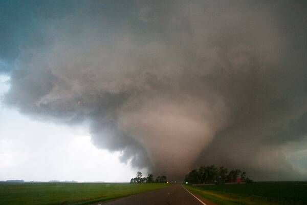 A tornado moves across the rural Conger countryside on June 17, 2010. The images were shot from Freeborn County Road 17 generally west of this tornado, which was increasing to EF4 strength at this point. In this image, it was directly over the farm of Jeff and Beth Zeller. Photo courtesy Benjamin and Michael Tillotson/TCS.net
