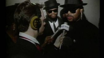 a group of people wearing black hats and holding microphones