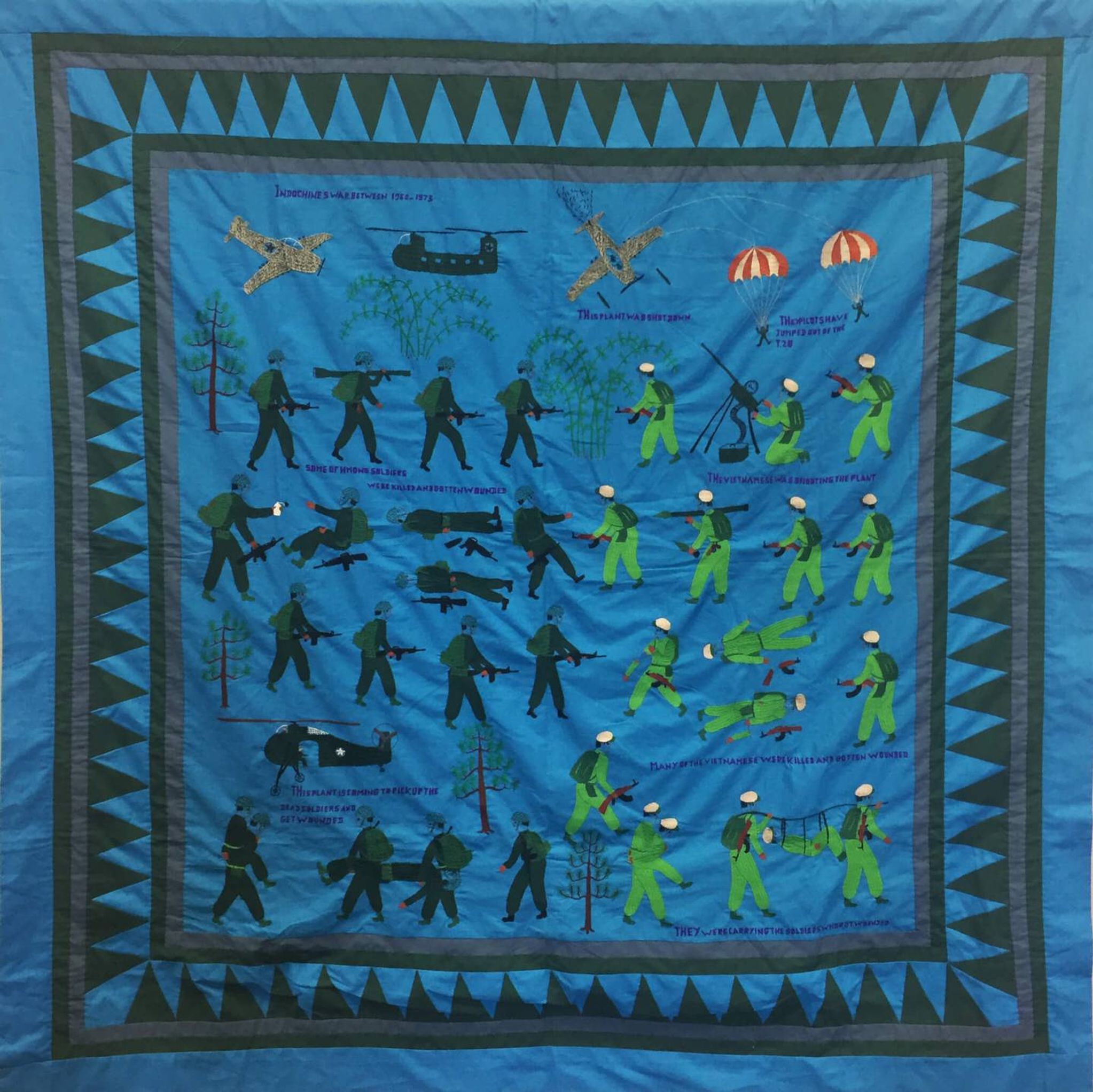 Blue Hmong tapestry featuring war scenes